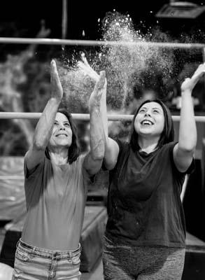 Coach Heidi and Coach Savannah tossing chalk in the air.